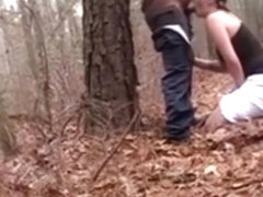 White streetslut sucks off a fat black guy in the forest