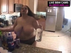 BBW poses in the kitchen