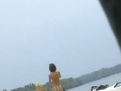 Topless sleek hotties on the nude beach getting filmed by a voyeur