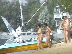 Hot beach voyeur video shows mature nudists enjoying each others company.