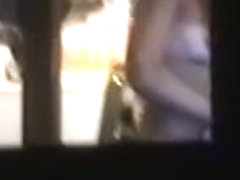 Sexy chick naked on a window voyeur video
