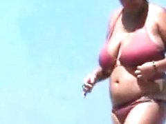 Woman with big breasts on the beach