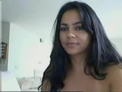 Dark haired hot latina girl plays with her pussy on the sofa